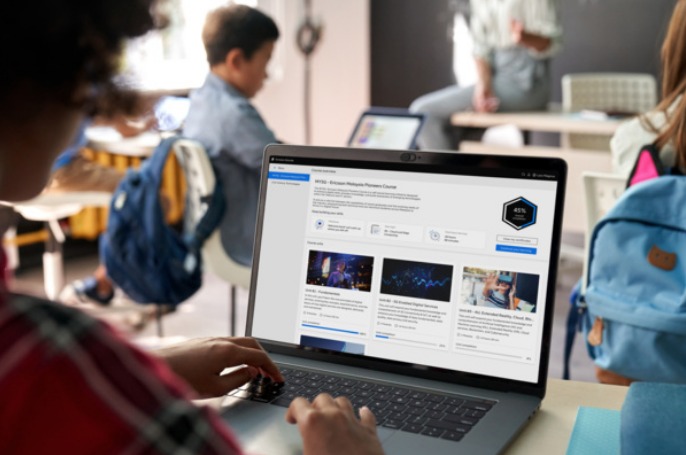 A student using the Ericsson Educate learning platform on a laptop in a classroom